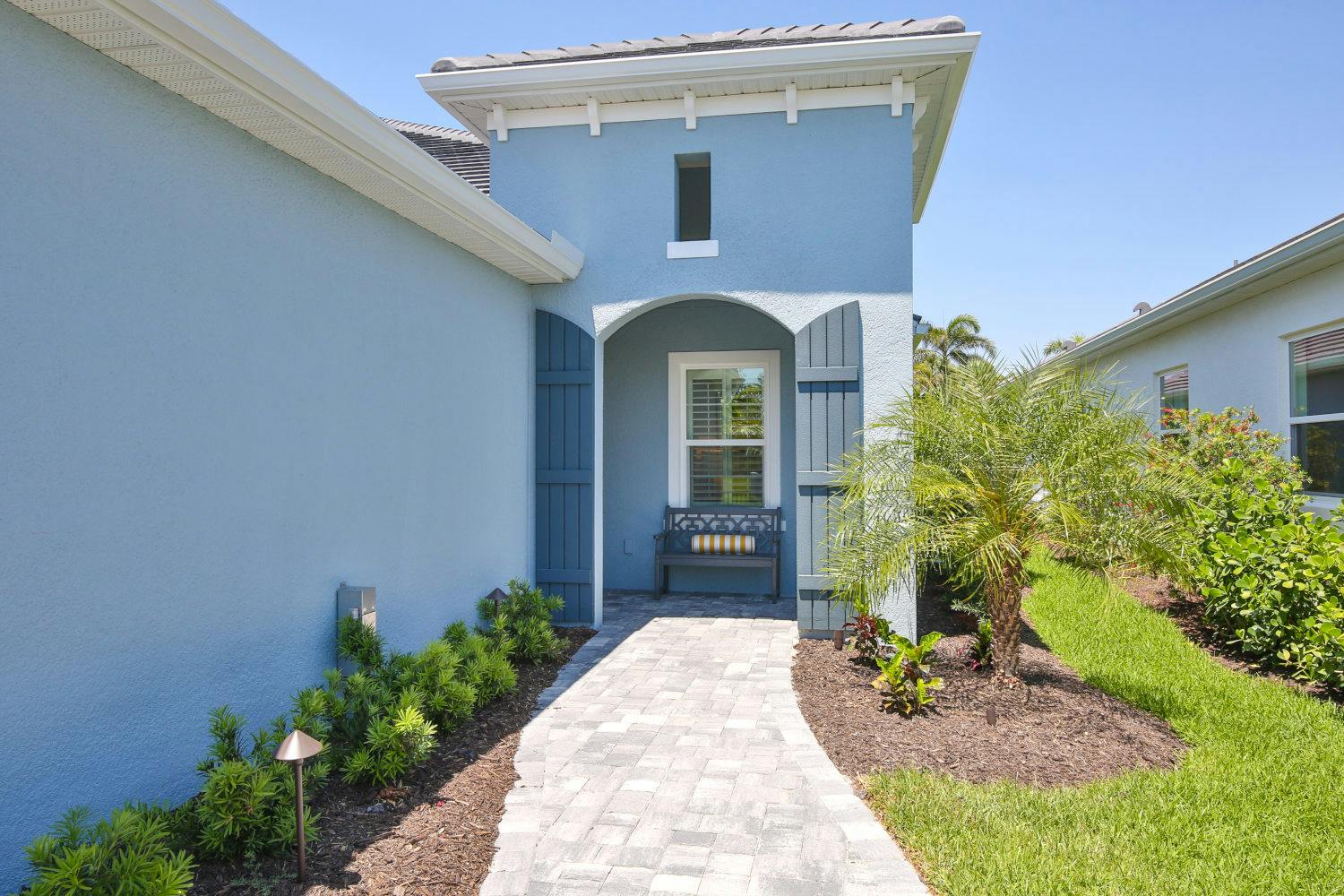 Landscaped entrance of the Tidewinds 2 villa by Neal Communities